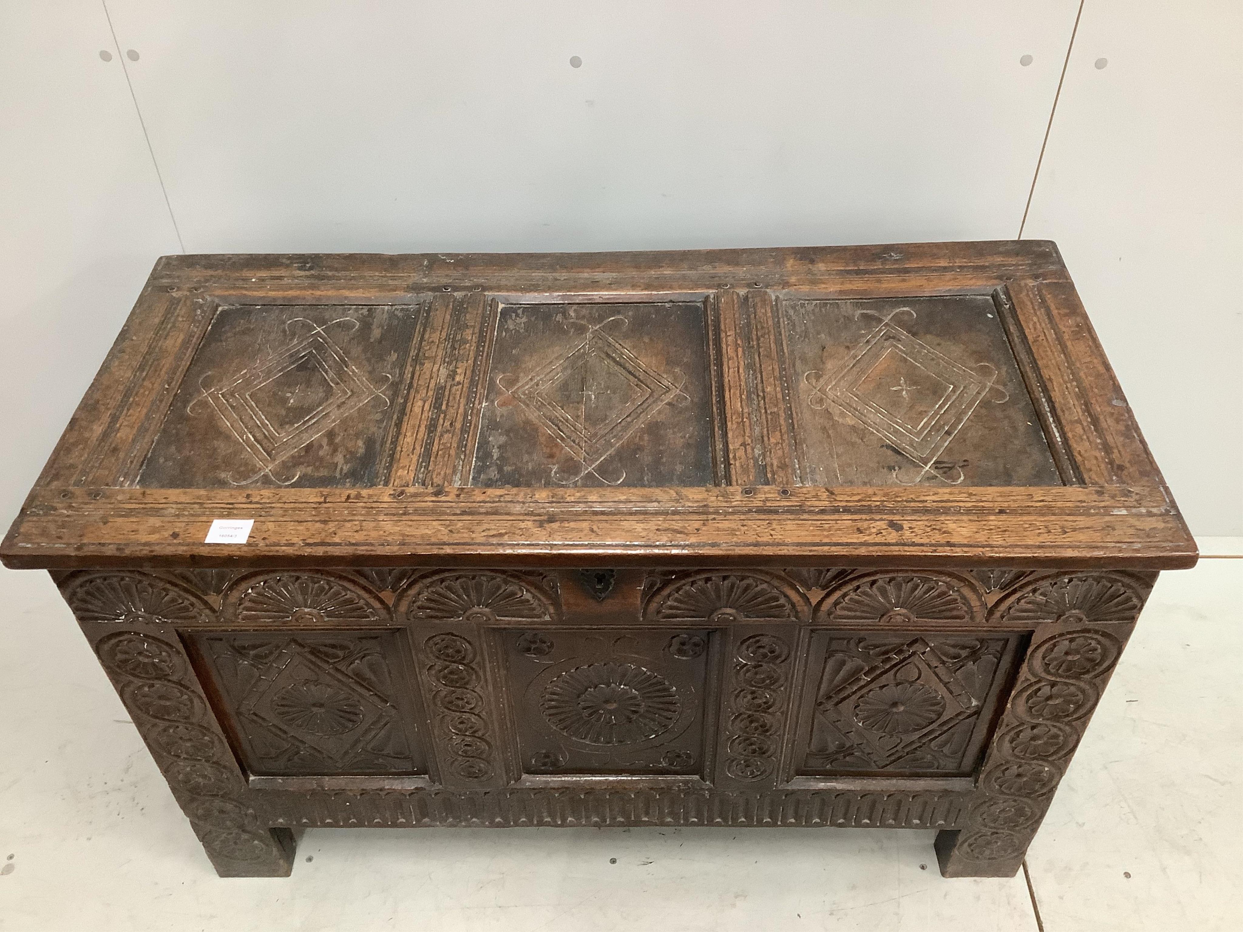 An 18th century carved oak coffer, width 117cm, depth 53cm, height 71cm. Condition - fair